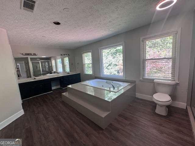 2000 Brickton Sta, Buford, GA 30518 - bathroom with baseboards, a stall shower, toilet, a bath, and a textured ceiling