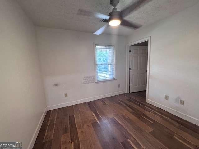 2000 Brickton Sta, Buford, GA 30518 - empty room with wood finished floors, ceiling fan, baseboards, and a textured ceiling