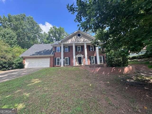 2000 Brickton Sta, Buford, GA 30518 - greek revival house with an attached garage and driveway