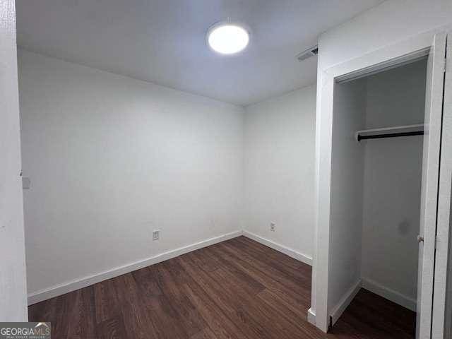 2000 Brickton Sta, Buford, GA 30518 - unfurnished bedroom featuring wood finished floors, a closet, and baseboards