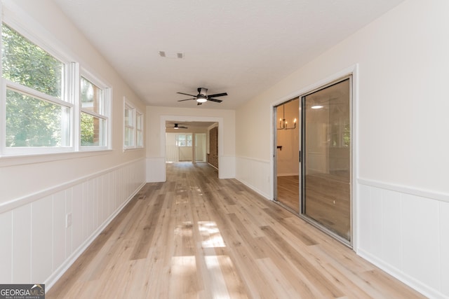 139 Old Oak Rd, Byron, GA 31008 - hallway with wainscoting, light wood-style floors, and a decorative wall