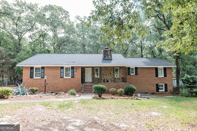 139 Old Oak Rd, Byron, GA 31008 - ranch-style house featuring a porch, brick siding, a chimney, and view of scattered trees