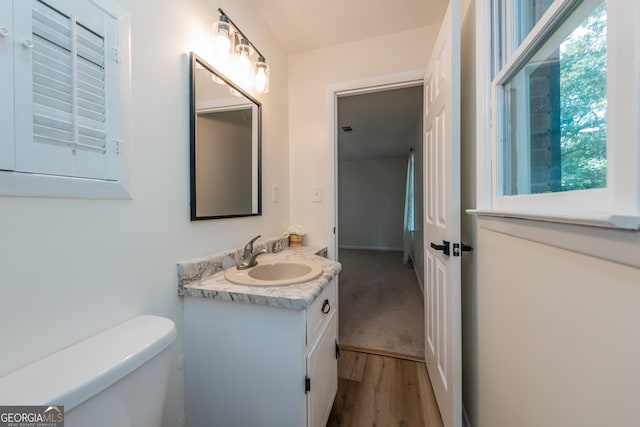 139 Old Oak Rd, Byron, GA 31008 - half bathroom featuring vanity, toilet, and wood finished floors