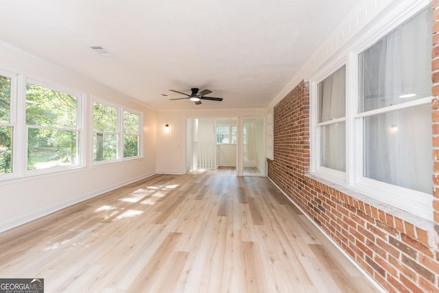 139 Old Oak Rd, Byron, GA 31008 - unfurnished sunroom with ceiling fan, brick wall, wood finished floors, baseboards, and crown molding