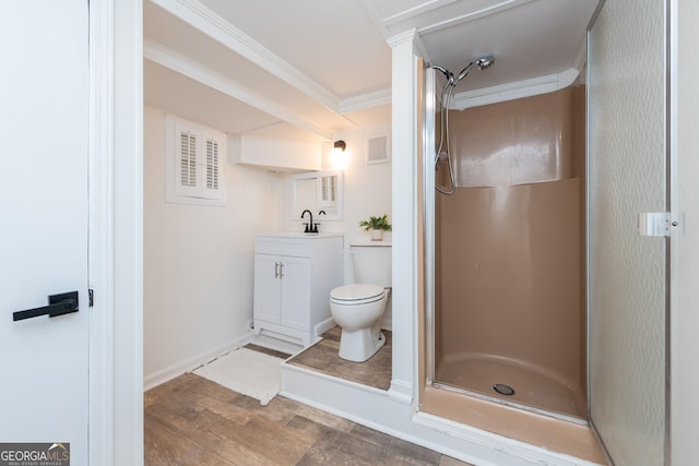 139 Old Oak Rd, Byron, GA 31008 - full bathroom with vanity, a shower stall, wood finished floors, toilet, and ornamental molding
