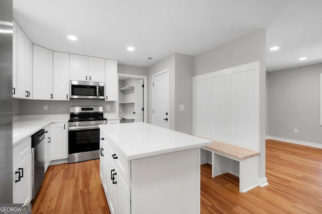 162 Langston Rd NE, Calhoun, GA 30701 - kitchen with stainless steel appliances, light wood-style flooring, light countertops, baseboards, and white cabinets