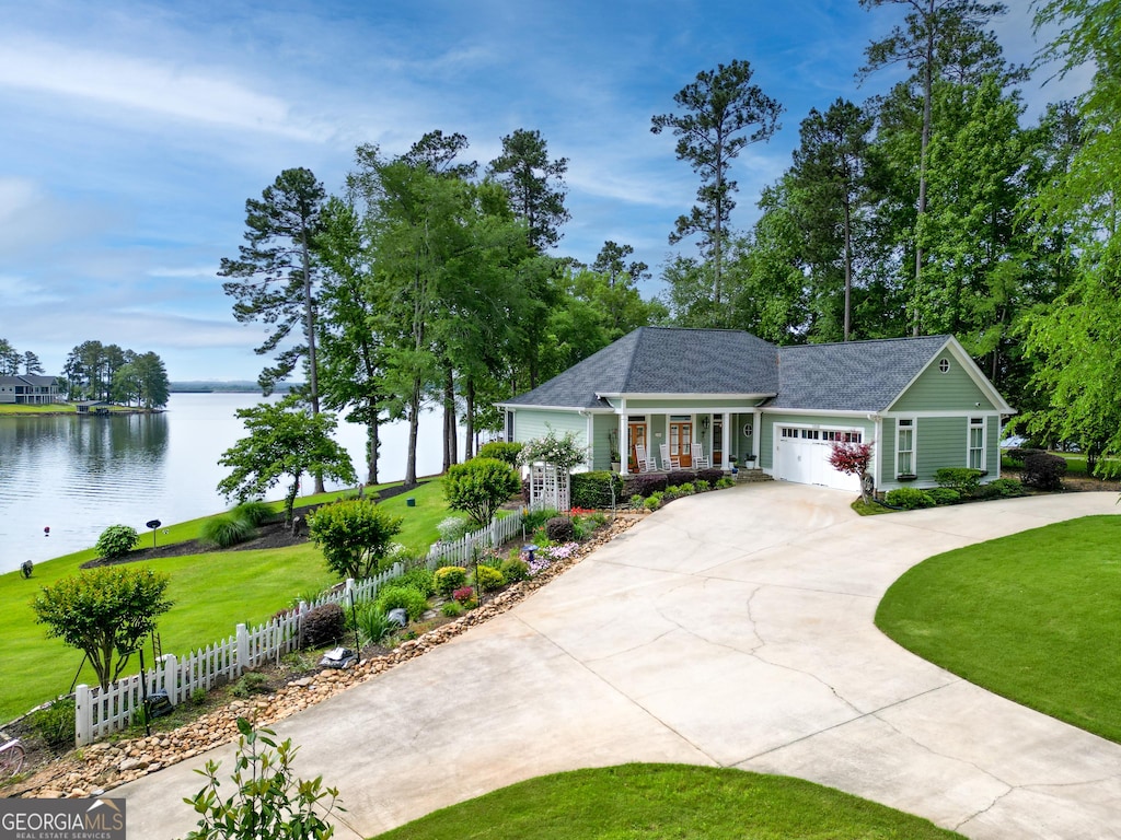 1058 Carrs Station Rd NE, Milledgeville, GA 31061 - ranch-style home with a water view, a garage, driveway, and roof with shingles