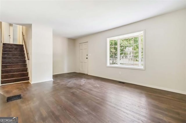 6192 Holiday Blvd, Forest Park, GA 30297 - unfurnished living room featuring wood finished floors and stairway