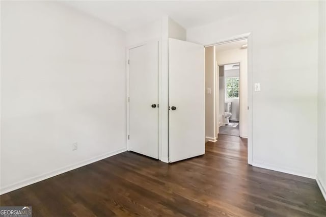 6192 Holiday Blvd, Forest Park, GA 30297 - unfurnished bedroom featuring dark wood-type flooring and baseboards