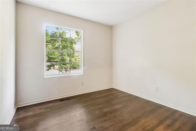 6192 Holiday Blvd, Forest Park, GA 30297 - spare room featuring dark wood-style flooring