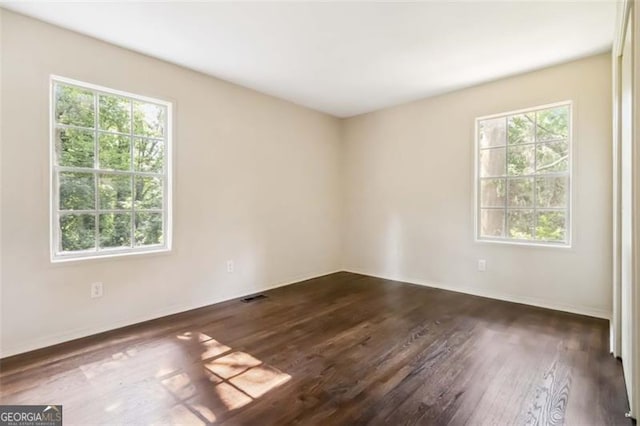 6192 Holiday Blvd, Forest Park, GA 30297 - unfurnished room featuring plenty of natural light and dark wood-type flooring