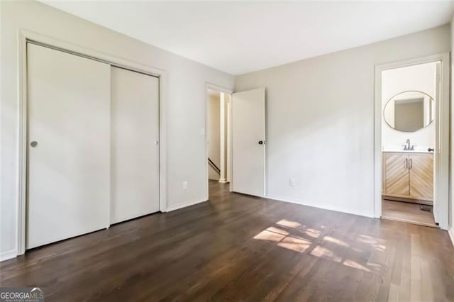 6192 Holiday Blvd, Forest Park, GA 30297 - unfurnished bedroom featuring wood finished floors, connected bathroom, and a closet
