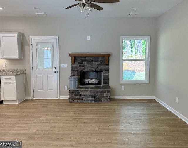 143 Roberts Quarters Rd, Concord, GA 30206 - unfurnished living room with light wood-style flooring, a ceiling fan, a fireplace, baseboards, and recessed lighting