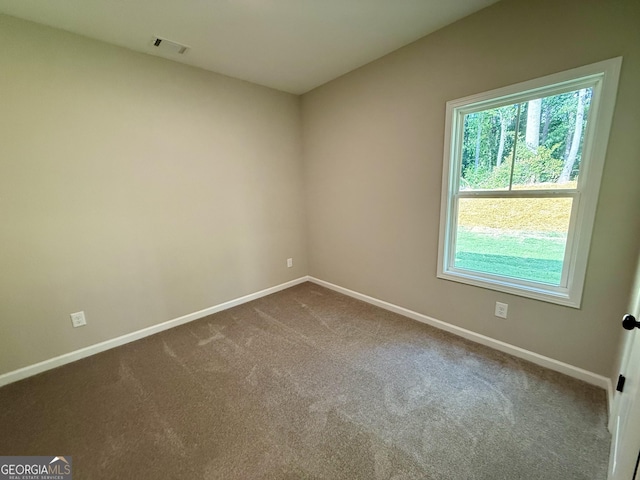 143 Roberts Quarters Rd, Concord, GA 30206 - spare room with baseboards and dark colored carpet