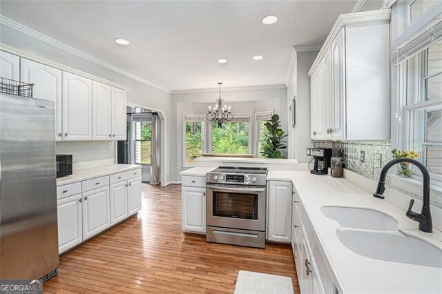 83 Shipp, Hiram, GA 30141 - kitchen featuring appliances with stainless steel finishes, a chandelier, white cabinetry, light countertops, and recessed lighting