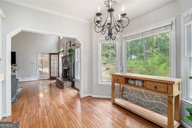 83 Shipp, Hiram, GA 30141 - dining room with hardwood / wood-style flooring, crown molding, a chandelier, and a fireplace