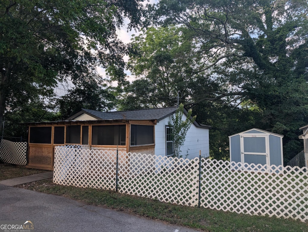 128 Branch St, Toccoa, GA 30577 - view of front of property featuring a sunroom and roof with shingles