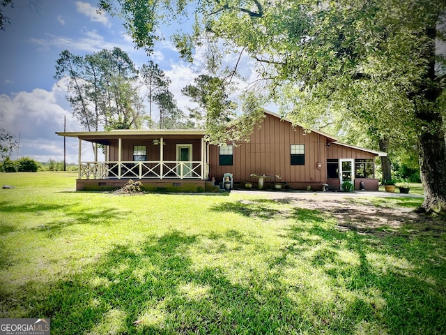 2618 Ga Highway 86, Adrian, GA 31002 - rear view of property featuring board and batten siding, covered porch, a lawn, and crawl space