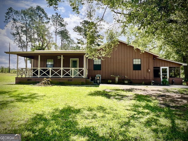 2618 Ga Highway 86, Adrian, GA 31002 - view of front facade featuring board and batten siding, a porch, a front lawn, and crawl space