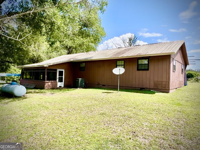 2618 Ga Highway 86, Adrian, GA 31002 - rear view of house featuring crawl space, a sunroom, metal roof, a yard, and central air condition unit
