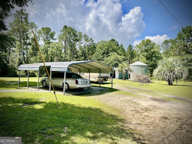 2618 Ga Highway 86, Adrian, GA 31002 - view of parking with driveway, a detached carport, and view of scattered trees