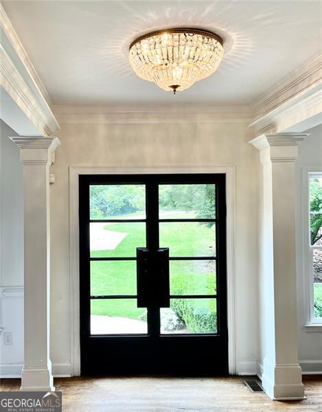 8525 Anchor On Lanier Ct, Gainesville, GA 30506 - entryway featuring ornate columns, crown molding, wood finished floors, and baseboards