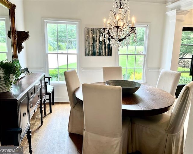 8525 Anchor On Lanier Ct, Gainesville, GA 30506 - dining space featuring healthy amount of natural light, wood finished floors, a chandelier, and crown molding