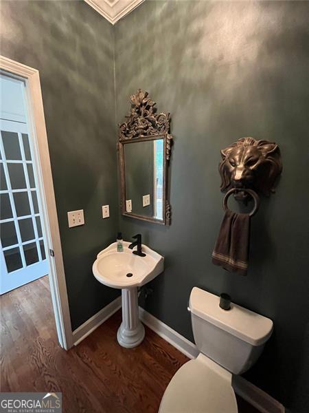 8525 Anchor On Lanier Ct, Gainesville, GA 30506 - half bathroom featuring wood finished floors, baseboards, toilet, and ornamental molding