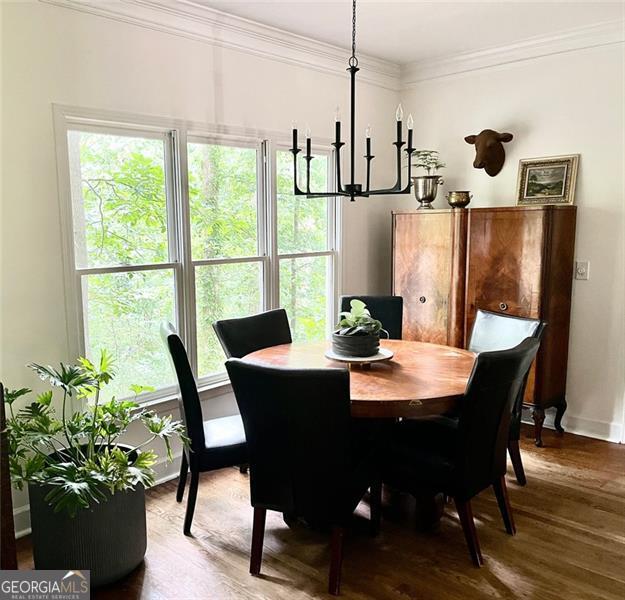 8525 Anchor On Lanier Ct, Gainesville, GA 30506 - dining space with a chandelier, wood finished floors, crown molding, and baseboards