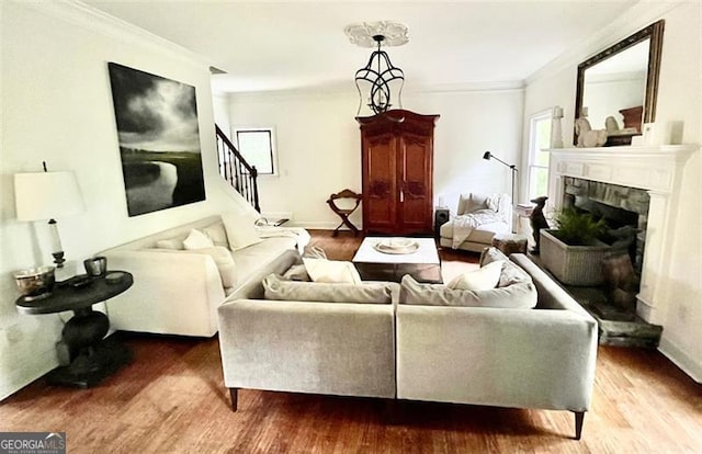 8525 Anchor On Lanier Ct, Gainesville, GA 30506 - living area featuring wood finished floors, ornamental molding, a fireplace with raised hearth, stairs, and baseboards