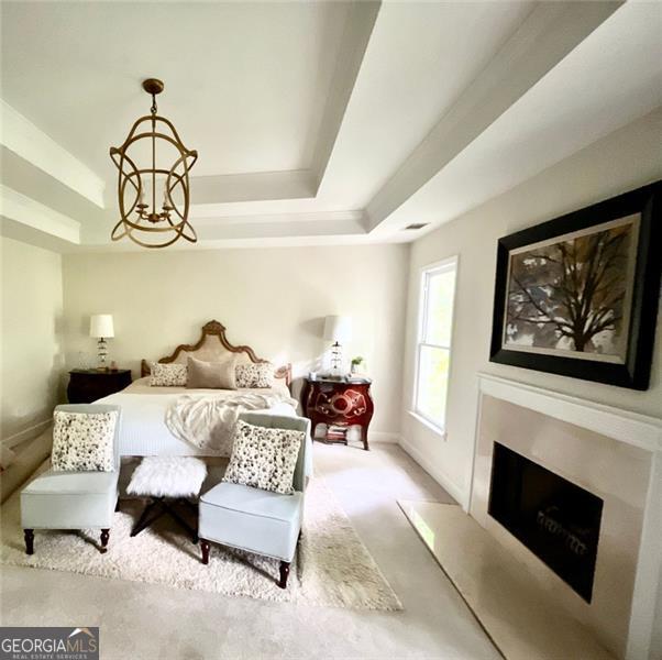 8525 Anchor On Lanier Ct, Gainesville, GA 30506 - carpeted bedroom with a tray ceiling, a fireplace, and baseboards