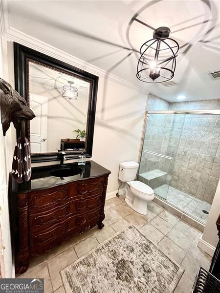 8525 Anchor On Lanier Ct, Gainesville, GA 30506 - bathroom featuring vanity, toilet, a stall shower, crown molding, and tile patterned flooring