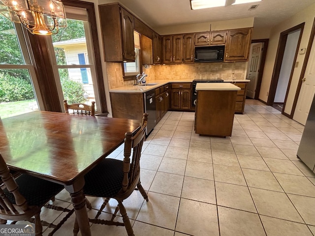 404 Windsor Way, Peachtree City, GA 30269 - kitchen with black microwave, stove, light countertops, and a sink