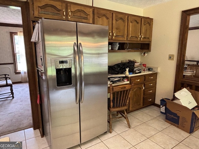 404 Windsor Way, Peachtree City, GA 30269 - kitchen with stainless steel fridge with ice dispenser, light tile patterned floors, light countertops, a desk, and light carpet