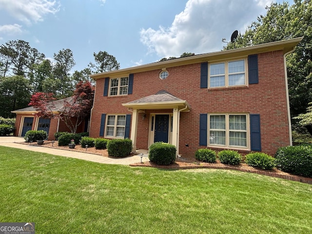 404 Windsor Way, Peachtree City, GA 30269 - colonial inspired home featuring a front yard, brick siding, and an attached garage