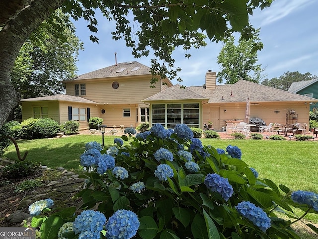 404 Windsor Way, Peachtree City, GA 30269 - back of house with a patio, a chimney, a yard, and a sunroom