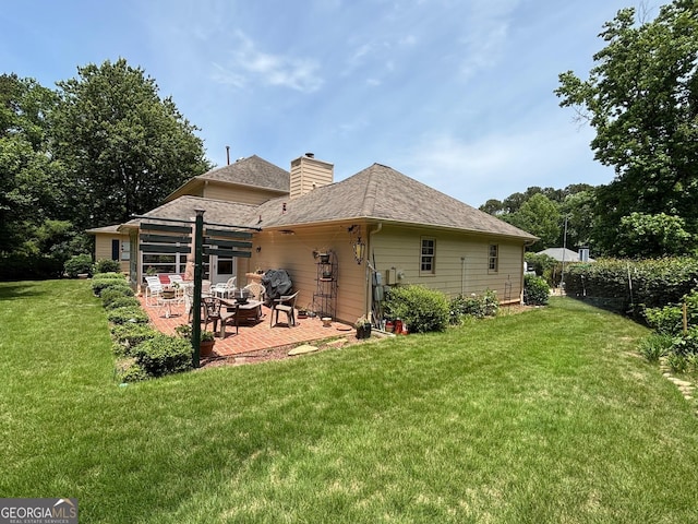 404 Windsor Way, Peachtree City, GA 30269 - back of property featuring a patio, a yard, a chimney, and roof with shingles