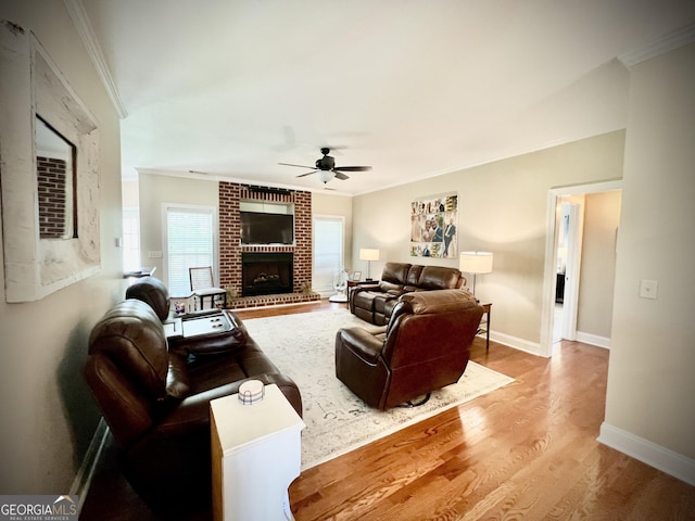 511 Live Oak Way, Dublin, GA 31021 - living room featuring crown molding, a ceiling fan, wood finished floors, baseboards, and a brick fireplace