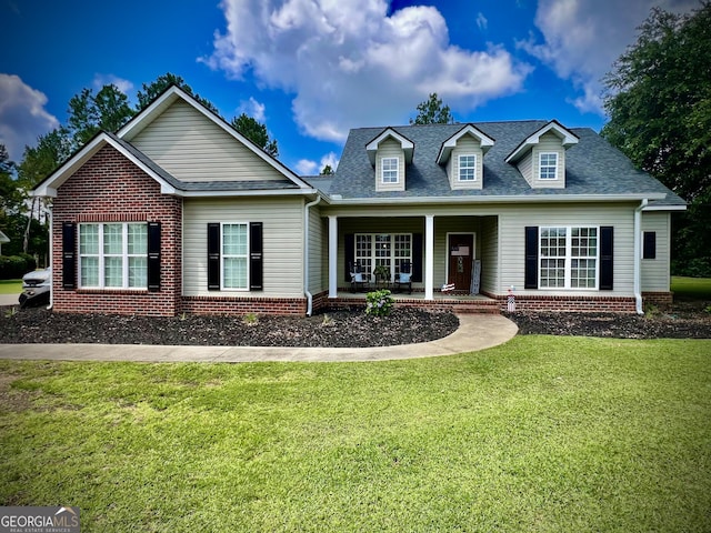 511 Live Oak Way, Dublin, GA 31021 - view of front of home featuring a porch, a front lawn, brick siding, and roof with shingles