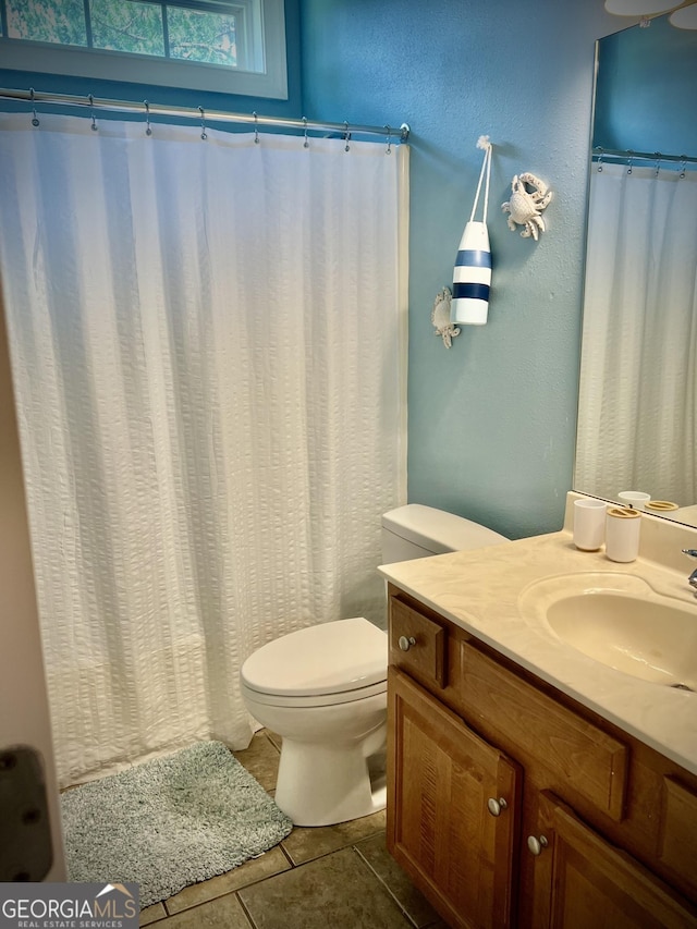 511 Live Oak Way, Dublin, GA 31021 - bathroom featuring vanity, toilet, tile patterned floors, and a shower with shower curtain