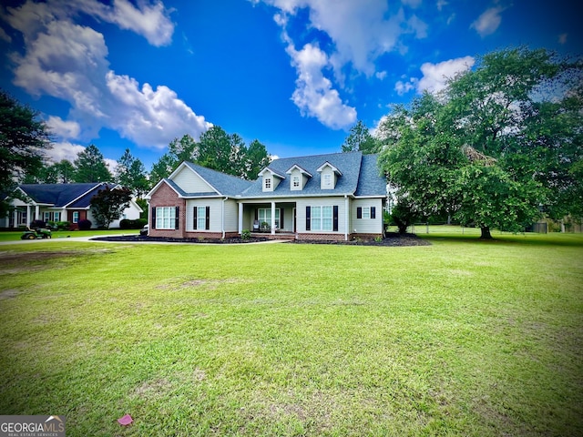 511 Live Oak Way, Dublin, GA 31021 - new england style home featuring a front lawn, a porch, and brick siding