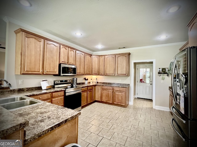 511 Live Oak Way, Dublin, GA 31021 - kitchen with appliances with stainless steel finishes, a sink, baseboards, ornamental molding, and brown cabinetry
