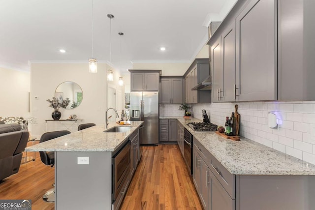 4457 Equity Ct, Ellenwood, GA 30294 - kitchen with stainless steel appliances, gray cabinetry, a sink, a kitchen bar, and ornamental molding