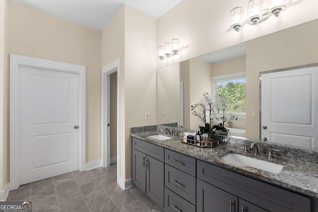 4457 Equity Ct, Ellenwood, GA 30294 - bathroom with double vanity, marble finish flooring, a freestanding tub, and baseboards