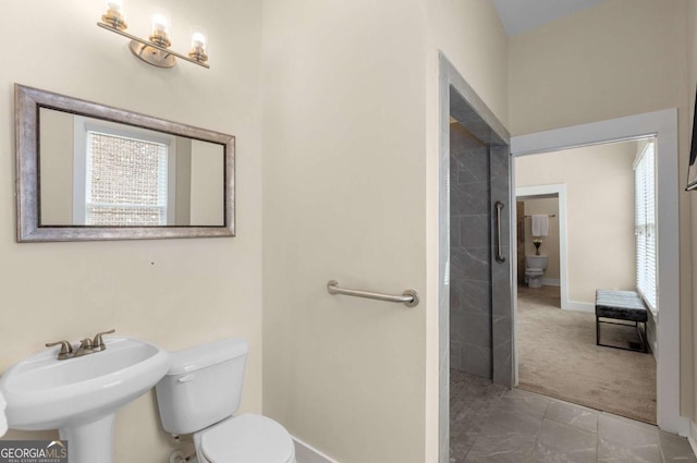 4457 Equity Ct, Ellenwood, GA 30294 - bathroom with toilet, baseboards, and a sink