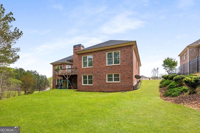 4457 Equity Ct, Ellenwood, GA 30294 - rear view of house with brick siding, a chimney, and a lawn