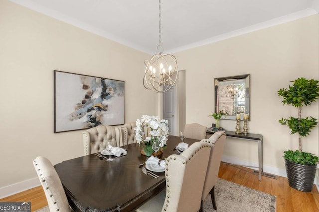 4457 Equity Ct, Ellenwood, GA 30294 - dining space with a chandelier, wood finished floors, and baseboards