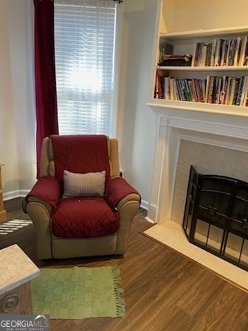 3955 Sweetwater Pkwy, Ellenwood, GA 30294 - living area featuring wood finished floors, a fireplace with flush hearth, and baseboards
