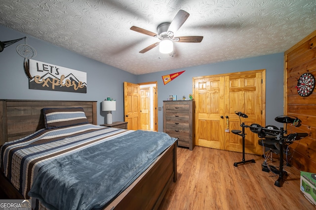 149 Savior Ln, Hamilton, GA 31811 - bedroom featuring light wood finished floors, a textured ceiling, and a ceiling fan