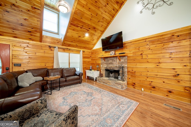 149 Savior Ln, Hamilton, GA 31811 - living area featuring wooden ceiling, wood walls, a fireplace, wood finished floors, and a skylight